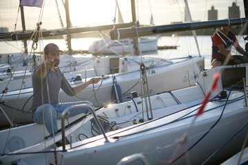 Tourist walks on sailing yachts. Male tourist on vacation on a boat at the sea.