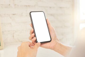 cell phone blank white screen mockup.hand holding texting using mobile on desk at office.background empty space for advertise.work people contact marketing business,technology