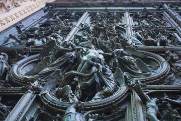Pieta scenes on the bas relief of Milan Cathedral door in Milan