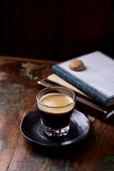 Coffee in glass cup on dark wooden background. Copy space.	