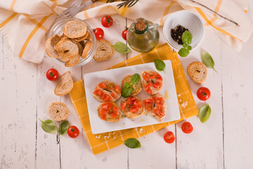 Friselle with cherry tomatoes and basil.