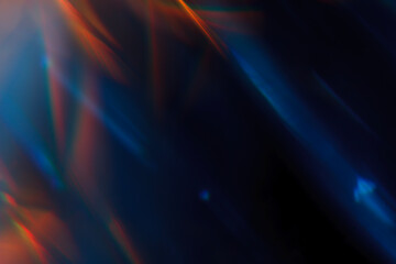 Colorful light leak on black background, abstract design with optical lens flare shot on a long lens.