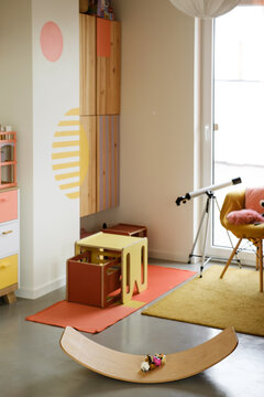 Kids Play Room, Nobody. Nice Sunny Bright Interior At Home. Play And Rest And Create, Store Things And Climb On The Wall, Balance Board Curvy Rocker Board Used For Motor Physical Development