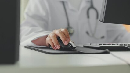 Closeup shot doctor's hand using computer working in hospital