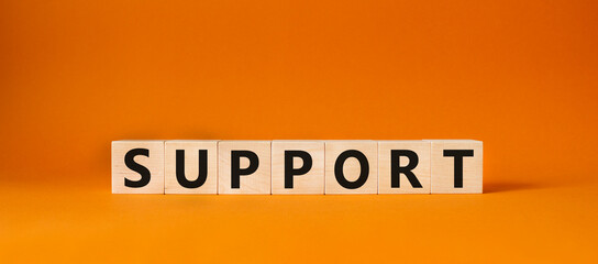 Support symbol. Concept word Support on wooden cubes. Beautiful orange background. Business and Support concept. Copy space.