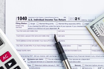 Obraz premium Flat lay of Individual income tax return form for tax payment on working desk. Background for Data analysis, paperwork, financial research, report. Calculation tax return in 2022