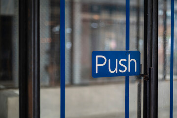 Restaurant door handle with push sign on glass doors
