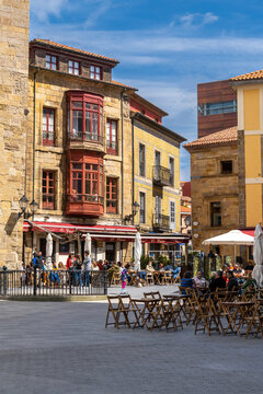 view of the lively and busy Plazuela de Marquez square with many people enjoying a sunny weekend day