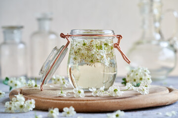 A jar filled with hawthorn flowers and alcohol - preparation of tincture