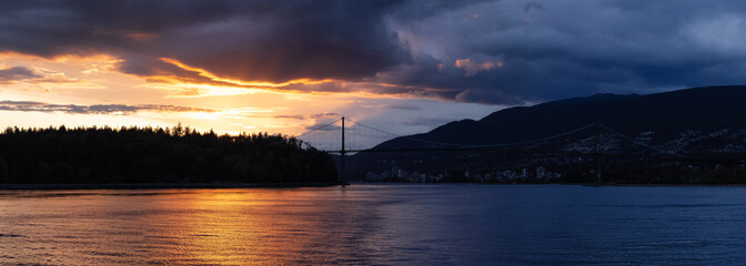 Stanley Park, Lions Gate Bridge and City with Mountains in Background on the West Coast of Pacific Ocean. Dramatic Sunset. Vancouver, British Columbia, Canada.