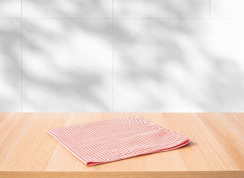 Red fabric,cloth on wood table top on wall background.