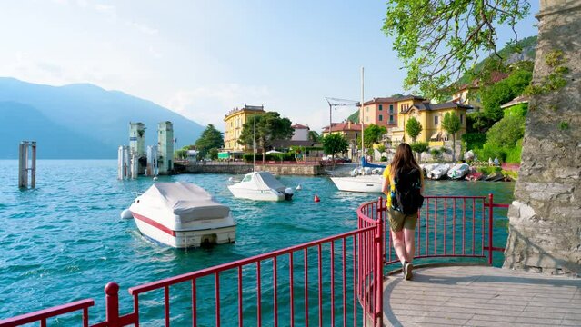 Beautiful blonde girl in Varenna, the Lombard village of lovers on Lake Como. Small village of Varenna is the perfect place for a romantic weekend. The Walk of Lovers is pedestrian path over water
