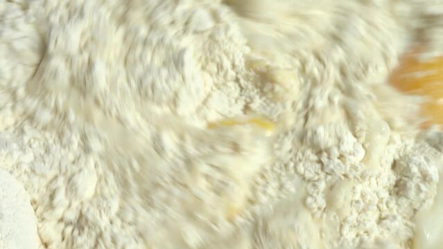 The process of making dough from flour, milk and eggs.