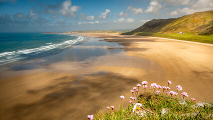 Summer sky warm day in Rhossili beach south wales view over the ocean - obrazy, fototapety, plakaty