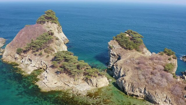 Aerial view of a rocky promontory with a strait between the rocks. Beautiful bay Orlinka (Warm) with clean and clear water. Marine reserve. Untouched nature.