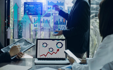 Business people hands working on digital finance marketing chart with future technology innovation and digital transformation concept.