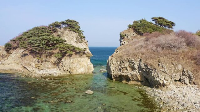 Aerial view of a rocky promontory with a strait between the rocks. Beautiful bay Orlinka (Warm) with clean and clear water. Marine reserve. Untouched nature.