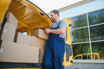 delivery service employee. Portrait of man working in delivery service. Portrait of courier with box. Courier next to minivan. Delivery service career.