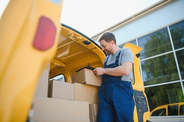 Courier service for the delivery of goods. Express service a man in a uniform delivers boxes. The employee carries the order home to the client.