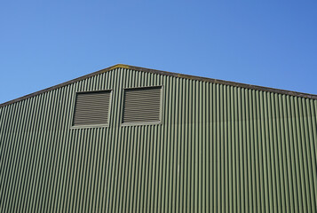 Industrial size warehouse hanger. Large metal barn for dry storage use on farm. rural outbuilding © Paul Cartwright
