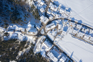 Fototapeta premium Aerial View of Itter Traditional Austrian village Covered by Snow in Winter Morning.