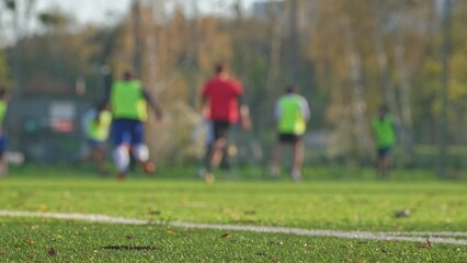 Anonymous Male Football Players Running on Soccer Field during Training Sparing Match