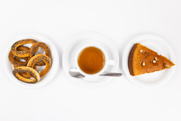 a white tea set with teapot tea and saucers and pie for breakfast