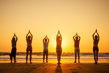 six health people in stand hatha position with hand up raced and breath full chest in Goa India beach at sunset - obrazy, fototapety, plakaty