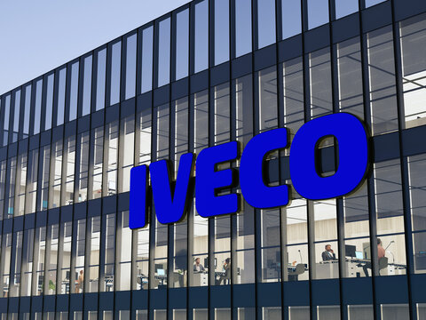 Turin, Italy. May 2, 2022. Editorial Use Only, 3D CGI. Iveco Signage Logo on Top of Glass Building. Workplace of Vehicle Manufacturer Company Office Headquarters.