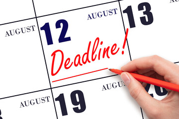 Hand drawing red line and writing the text Deadline on calendar date August 12. Deadline word written on calendar