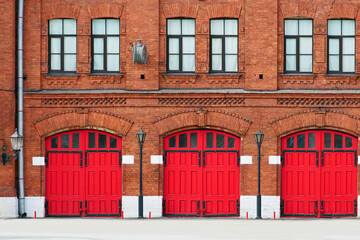 Fire station, an old historic brick building with red gates. Facade of an old fire department...
