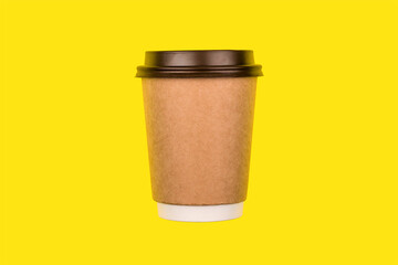 Paper glass with brown lid for drinks isolated on yellow background.