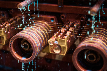 Cooling oil poured down on vintage coil winder machine tool