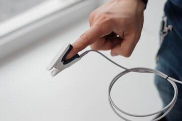 Pulse oximeter on a white background. Medical monitoring and diagnostic device for non-invasive...