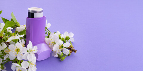Violet inhaler for bronchial asthma on a bright background with copy space. Inhaler on a background...
