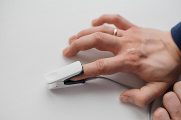 Pulse oximeter on a white background. Medical monitoring and diagnostic device for non-invasive...