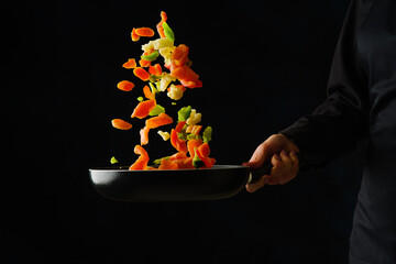 Seafood with vegetables in a pan on a black background. Frozen in-flight food. Bright composition....