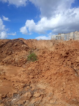 construction of a multi-storey building,large pile of sand and clay, building site
