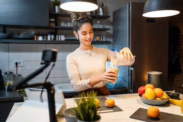 One woman young adult caucasian female making video or broadcast online as blogger about food...