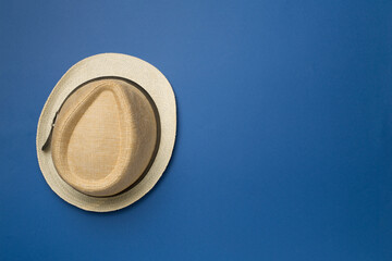 Straw hat on color background, top view