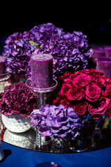 Obraz na płótnie Canvas Candle and beautiful flowers on the wedding table