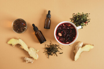 ginger, hibiscus brewed tea in a cup and two dropper bottles with pipettes, stress-reducing...