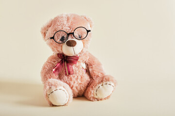Teddy Bear with eye Glasses on beige background