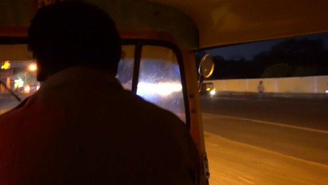 Travelling through the city of Mysore, India, on board a Tuk Tuk. Night