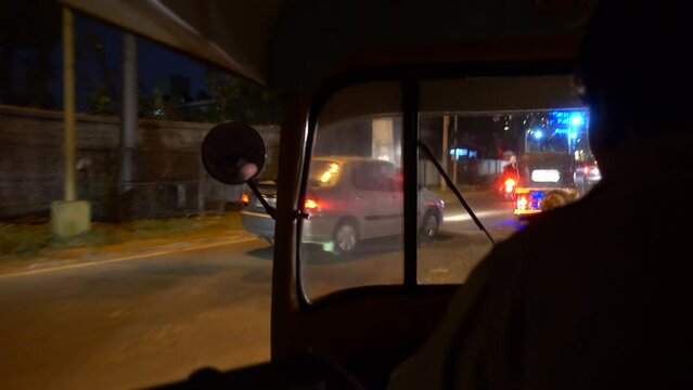 Travelling through the city of Mysore, India, on board a Tuk Tuk. Night