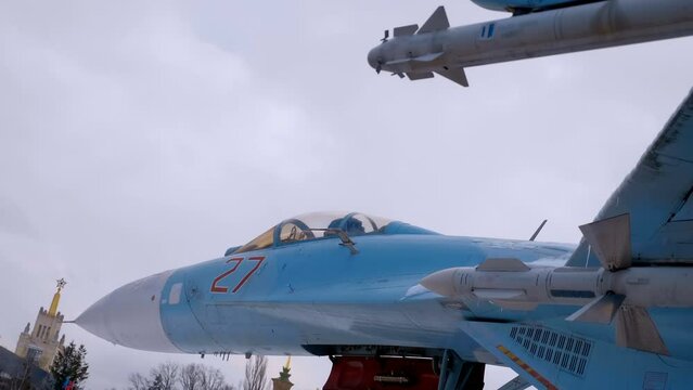 On the wing of a Russian fighter controlled missile "air-to-air", "air-to-ground", of radar or thermal homing against a blue sky with clouds. Shot in motion