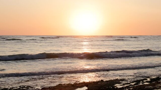 a zoom in shot of the sun setting from playa sirena beach at corcovado national park of costa rica