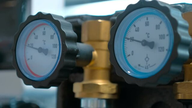 Samples of plumbing accessories - thermometers - for a reliable control in the heating and water supply system. Closeup. Shot in motion