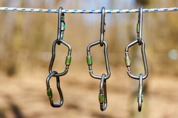 Carabiners for tourism on a blurred background with selective focus and copy space