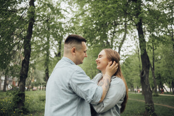 a couple in love in the park admires each other, laughs